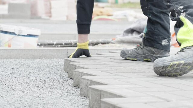 laying interlocking pavers during the construction of sidewalks and roads