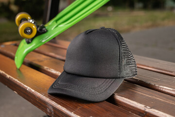 Trucker cap, snapback, all black, black mesh. In location on playground. Mock-up for branding