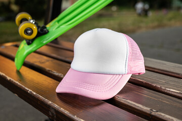 Trucker cap, snapback, pink with white front, pink mesh. In location on playground. Mock-up for branding