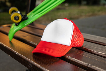 Trucker cap, snapback, red with white front, red mesh. In location on playground. Mock-up for branding