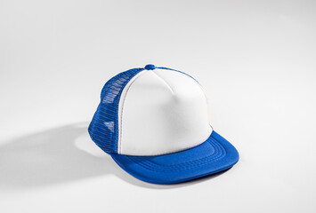 Trucker cap, snapback, blue with white front, blue mesh, firm. Isolated on white. Mock-up for...