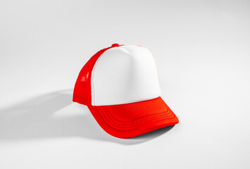 Trucker cap, snapback, red with white front, red mesh. Isolated on white. Mock-up for branding