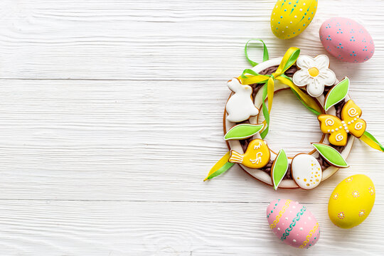 Easter sweet wreath made of bunny and eggs cookies, top view