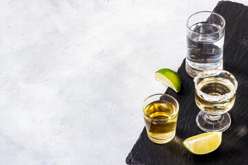 Alcohol in glasses with ice. Strong alcoholic drinks background