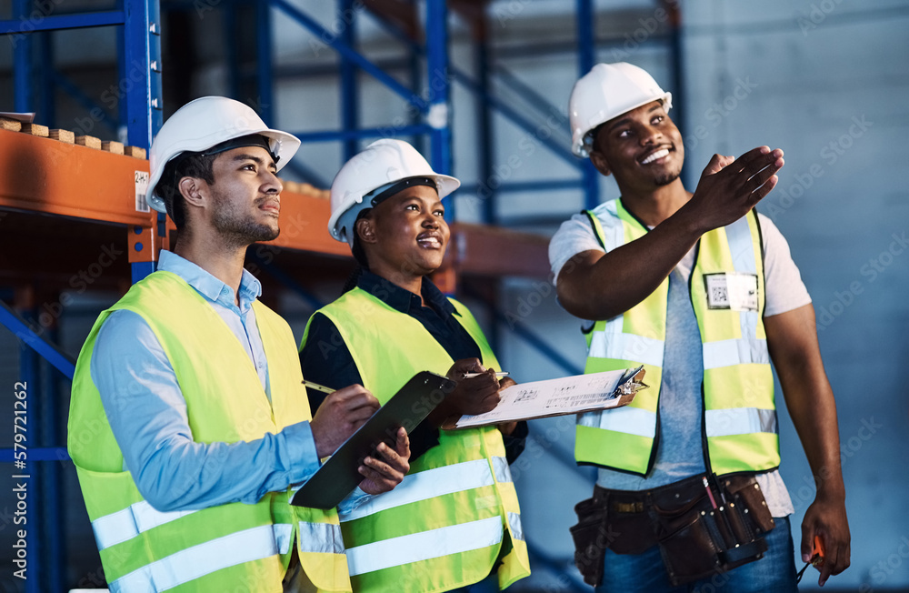Aufkleber this just came in. shot of a group of contractors standing in the warehouse and looking contemplativ