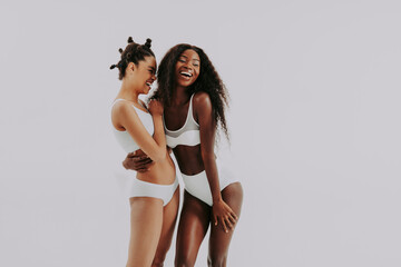 Beautiful black women wearing lingerie underwear posing in studio - Multicultural female models...