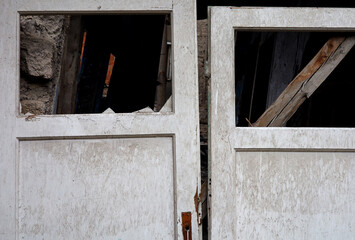 old broken wooden doors of destroyed house