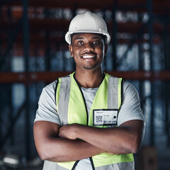 Your shipment is safe in our warehouse. Shot of a handsome young contractor standing alone in the warehouse with his arms crossed.