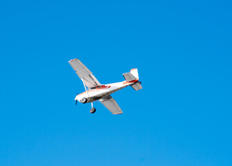 Lookup up a small airplane light aircraft under sunny clear blue sky near seaplane base in Anchorage, Alaska