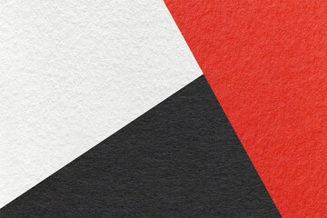 Texture of craft white, red and black shade color paper background, macro. Vintage abstract cardboard