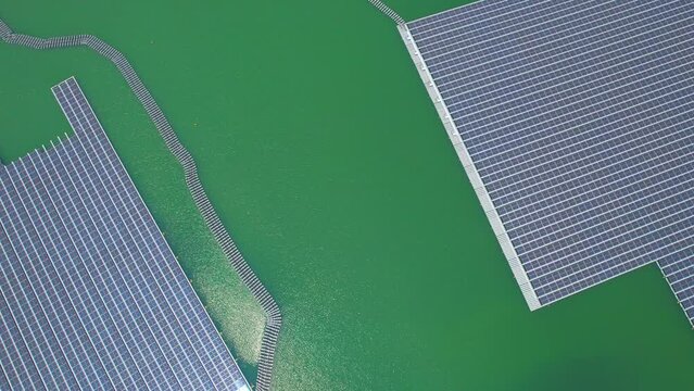 Floating solar panels harnessing clean energy from the sun while reducing land use and water evaporation, captured from aerial drone perspective. solar energy and environment concept. 4K HDR
