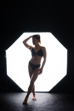 Silhouette of a beautiful young woman wearing underwear in backlight