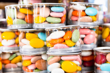 Dragee Candies in stacked transparent plastic jars