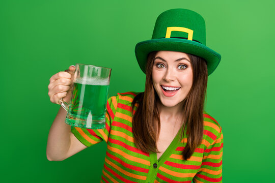 Photo of cheerful lady celebrate saint patrick day with her friends in pub toast craft lager isolated on green color background