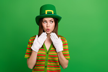 Photo of funny impressed young lady leprechaun look away saint patrick discounts isolated on green color background