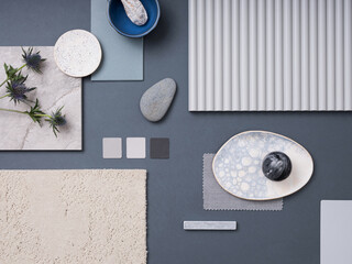Creative flat lay composition with textile and paint samples, panels and cement tiles. Stylish interior designer moodboard. Blue and grey color palette. Copy space. Template.