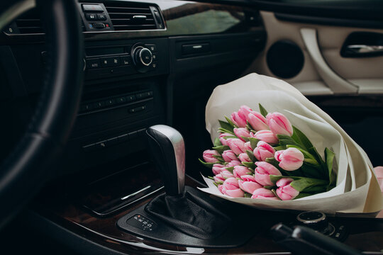 Bouquet of pink tulips lying in car