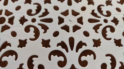 Abstract pattern on white plastic. Background. Texture. Abstract drawing for background and texture. Stencil for drawing with a pattern of flowers