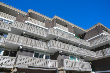 Exterior of Petticoat Square, part of the Middlesex Street Estate in the City of London, featuring slotted concrete balconies