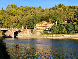 Fototapeta na wymiar The river Po in Turin through the historic center of the city and you can see the Mole Antonelliana, the Valentino castle, the Isabella bridge.