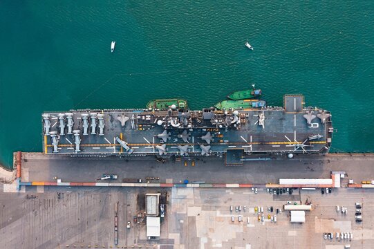 Amphibious Assault Ship USS Makin Island (LHD 8). Wasp Class Amphibious Assault Ship, Military Sea Transport, Military Navy Rescue Helicopter On Board The Battleship Deck, Amphibious Assault Ship