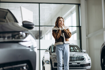 Woman bying a car in a car showroom