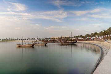 Fototapeta premium Doha skyline seen from MIA park and three dhow boats in the foreground.