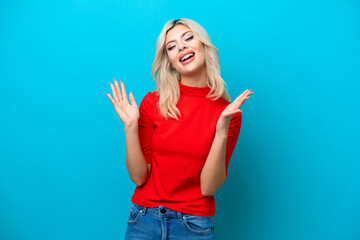Fototapeta premium Young Russian woman isolated on blue background smiling a lot