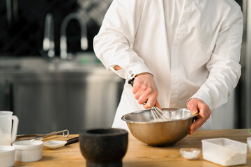 Fototapeta na wymiar Professional kitchen chef prepares pancakes kitchen utensils
