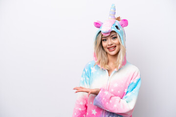 Fototapeta premium Young Russian woman with unicorn pajamas isolated on white background presenting an idea while looking smiling towards