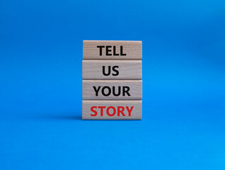 Tell us your story symbol. Concept words Tell us your story on wooden blocks. Beautiful blue background. Business and Tell us your story concept. Copy space.
