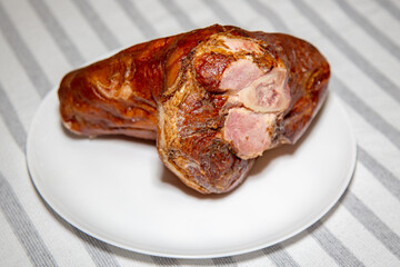Smoked pork knuckle, traditional German dish, isolated portrait and in selective focus
