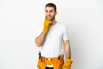 Young electrician man over isolated white wall thinking an idea while looking up