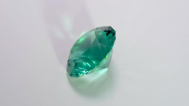 A full 360 degrees video of a self-cut Aquamarine Spinel with Standard Round Brilliant (SRB) cut, placed on a turntable covered with white Photopaper