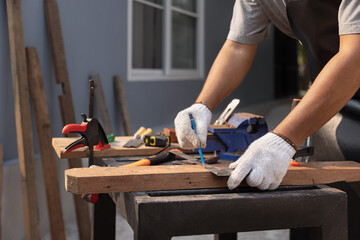 Woodworking is a hobby for male senior after retirement at home.