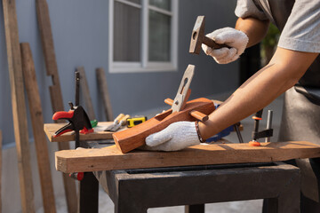 Woodworking is a hobby for male senior after retirement at home.