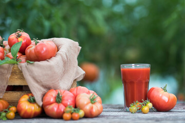 Fresh red tomato juice, on a wooden background
