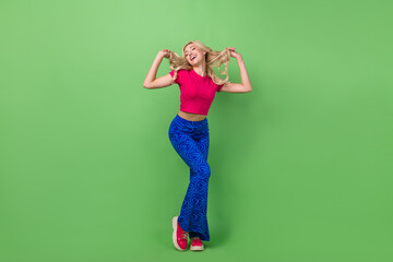 Full length photo of funny sweet woman wear pink top having fun dancing isolated green color background