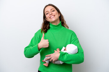 Young caucasian woman with her cute baby isolated on white background with thumbs up because something good has happened