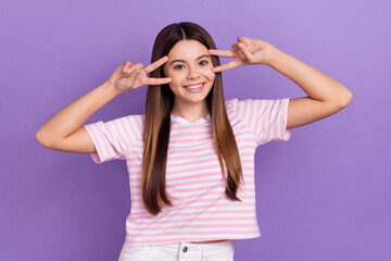 Photo of charming adorable girl dressed striped t-shirt showing two v-signs cover eyes isolated purple color background