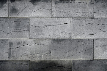 Wall surface with polished gray volcanic lava stone blocks - 579752820