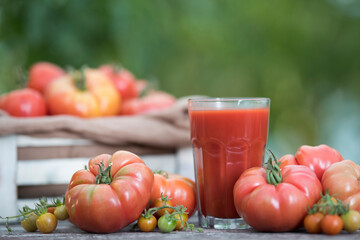 Fresh red tomato juice, on a wooden background