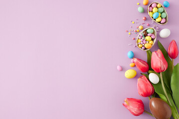 Easter concept. Top view photo of chocolate eggs with сolorful dragees and tulips flowers on isolated violet background with empty space