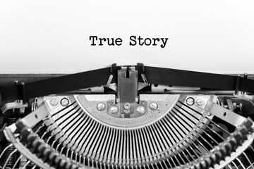 True Story word closeup being typing and centered on a sheet of paper on old vintage typewriter...