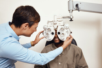 Your eyes are too important not to get them checked. Shot of an optometrist examining her patients...