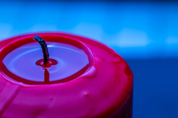 An extinguished candle with frozen wax close-up.