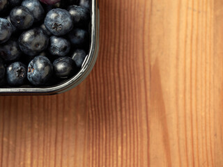 Freshly picked blueberries in a white vintage ceramic bowl. Selective focus, Free text space.