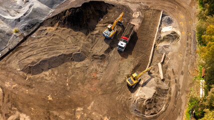 Aerial view of a stone and sand quarry. Trucks are loading material for transformation into gravel...