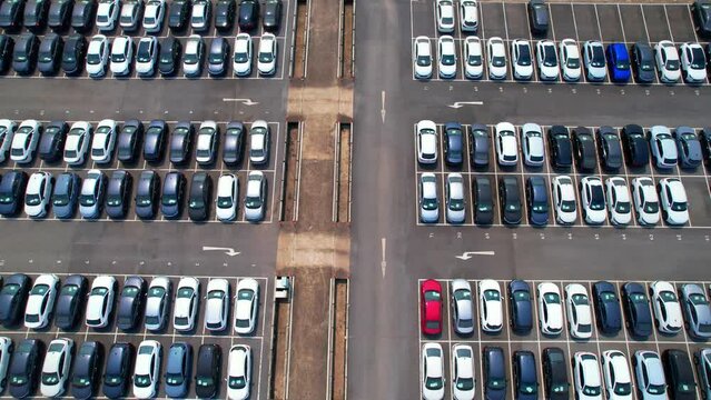 A drone flying over a factory parking lot filled with many cars could provide stunning stock footage for a variety of applications. The footage could be used in video productions, commercials. 4K
