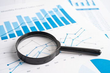 Magnifying glass on graph paper. Financial development, Banking Account, Statistics, Investment Analytic research data economy, Business concept.